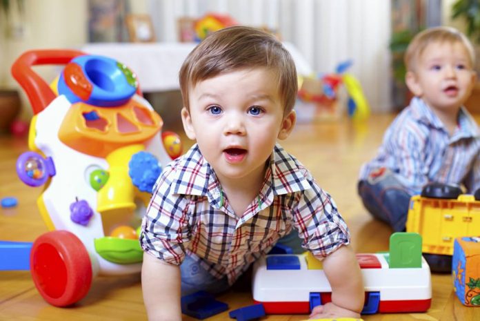 curious baby boy studying nursery room peuterspeelzaal